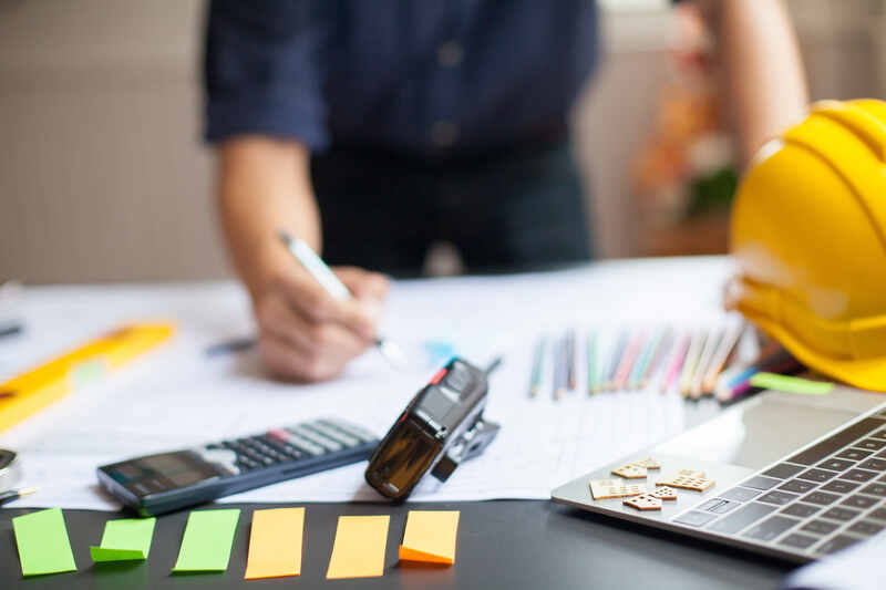 Price increase agreement contractor working with papers on desk
